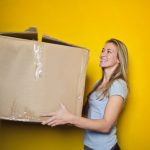 Woman Moving Box to illustrate how to choose a reputable moving company