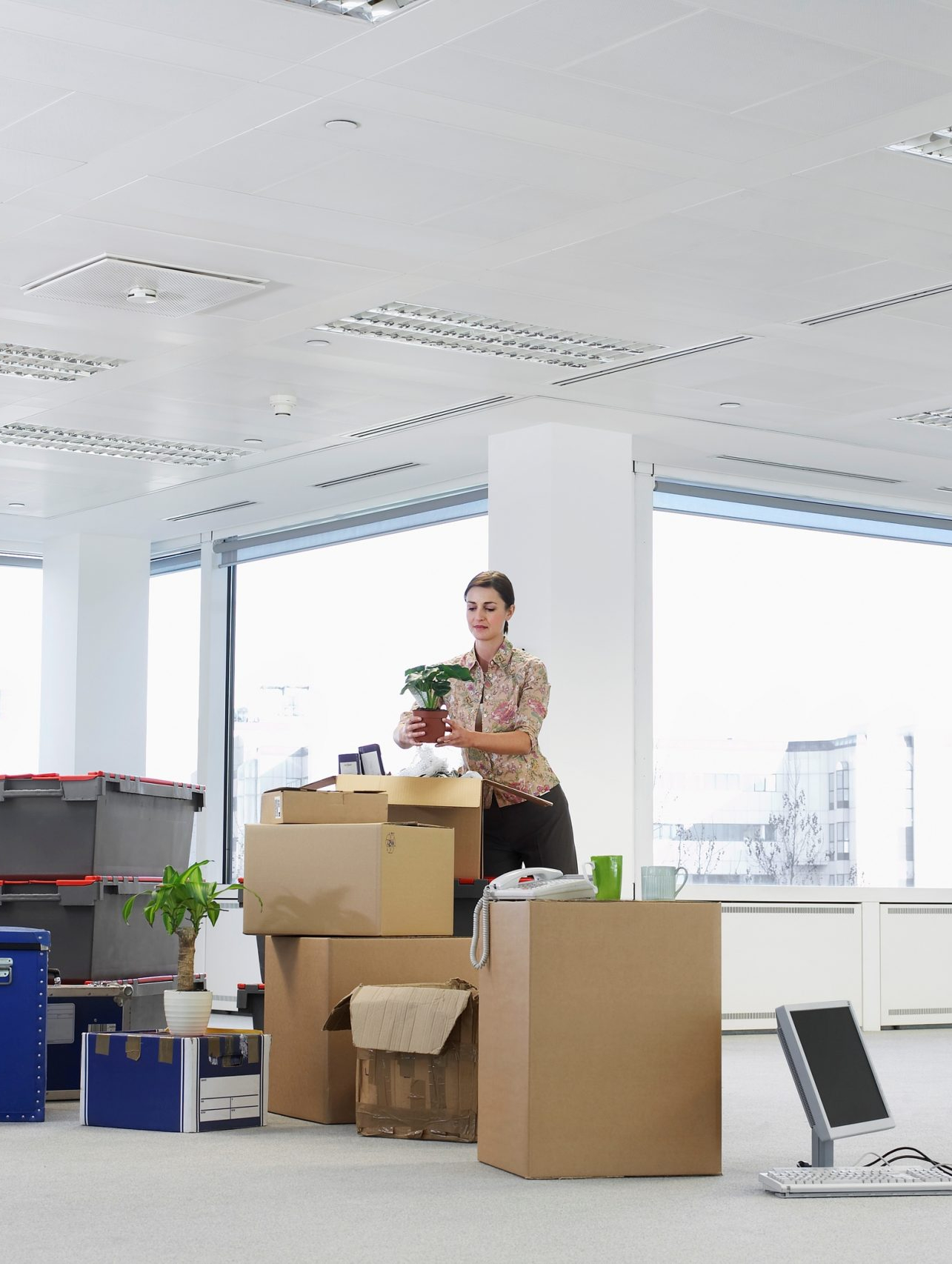 Photo of an office worker packing her office for a move