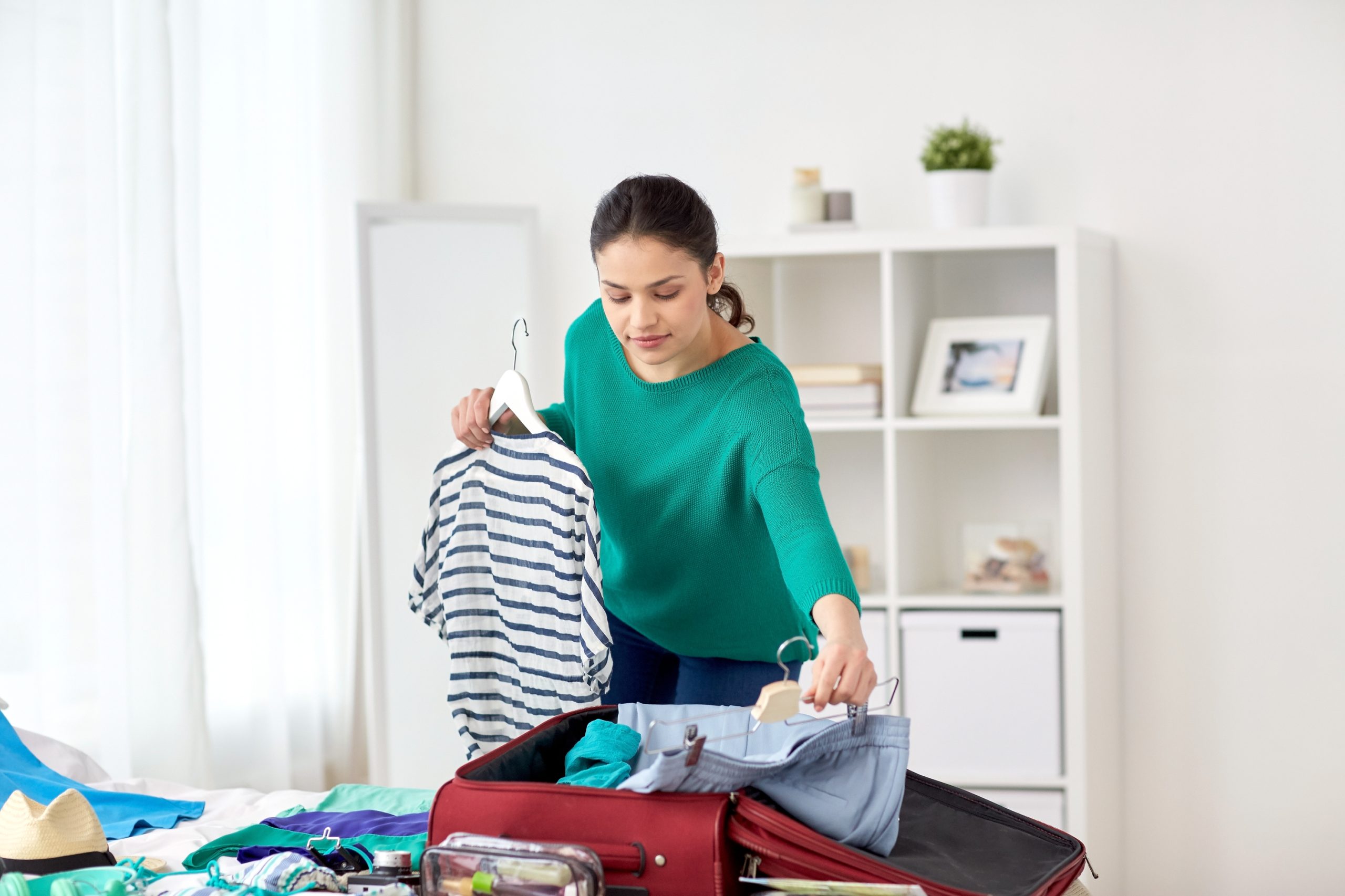 woman packing suitcase to illustrate Packing Hacks For Moving Checklist The Ultimate Moving Tips