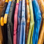 Colorful summer dresses on hangers to illustrate Packing Hacks For Moving The Ultimate Moving Tips