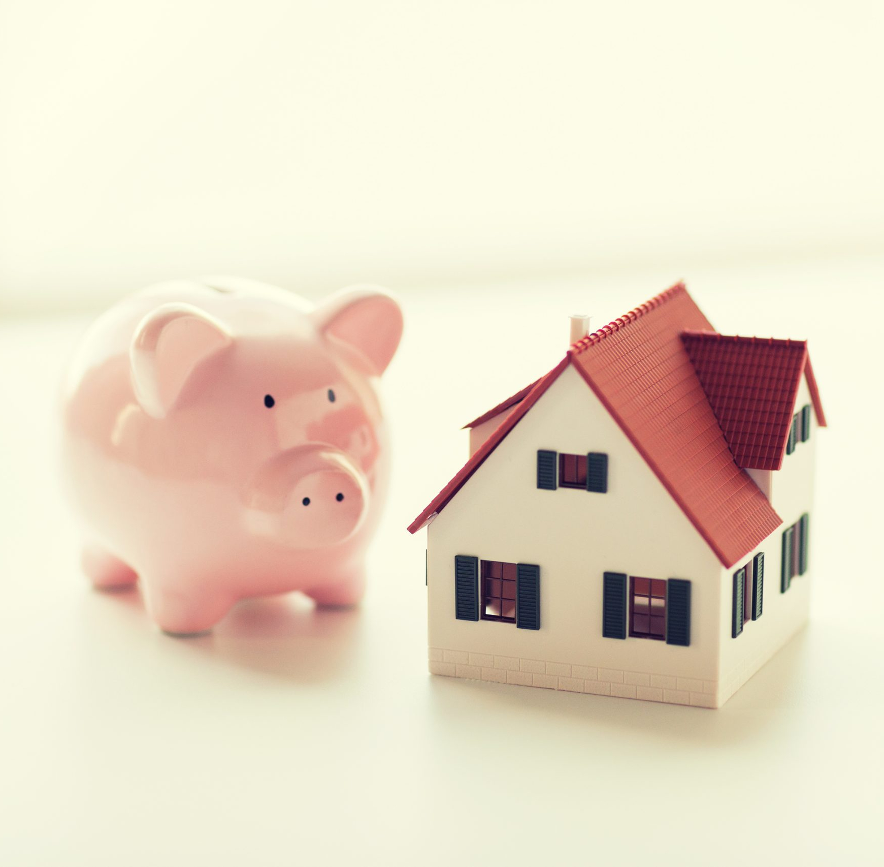 close up of house model and piggy bank to illustrate Cheapest Moving Company Rates Find the Most Affordable Move and Oregon City movers