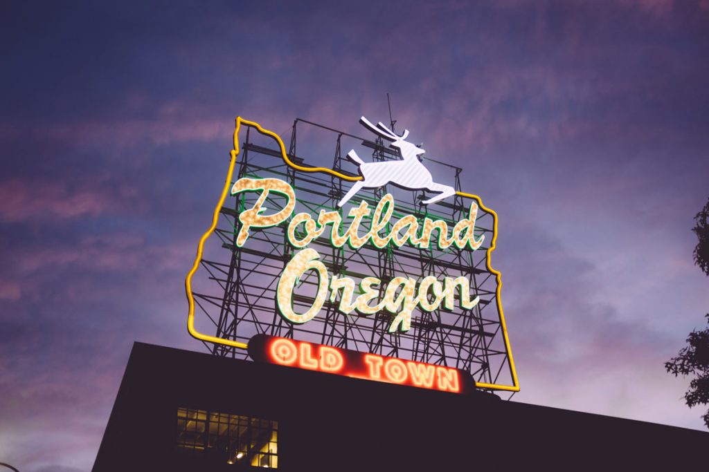An image of the Whit e Stag Portland Oregon sign in downtown at night Top 10 Portland neighborhoods